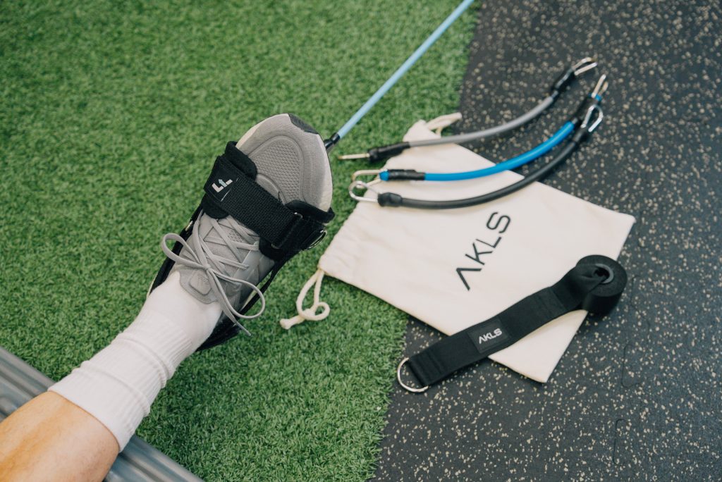 the AKLS ankle strengthening device for ankle rehab attached to foot